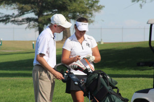 Abby Sauber talks to her coach, Mark Berger.  Photo by Katie Gross