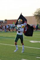 Zach Roth running out with the Chris Norgren vengeance flag.