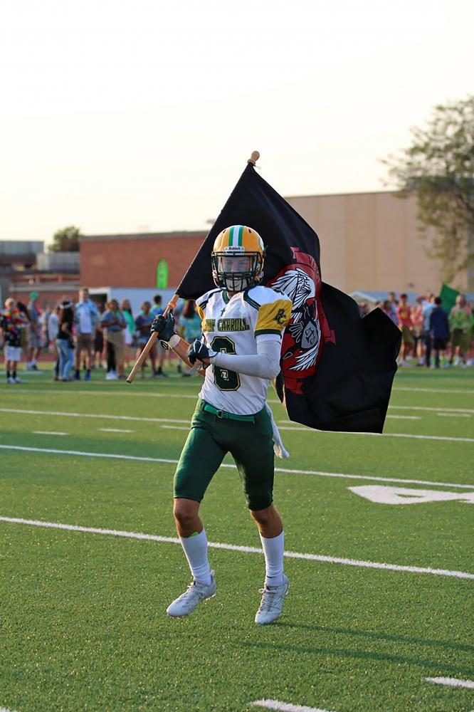 Zach Roth running out with the Chris Norgren vengeance flag. 