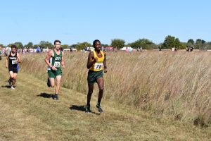Junior Eric Nganga races in the cross country meet at El Dorado on Saturday.