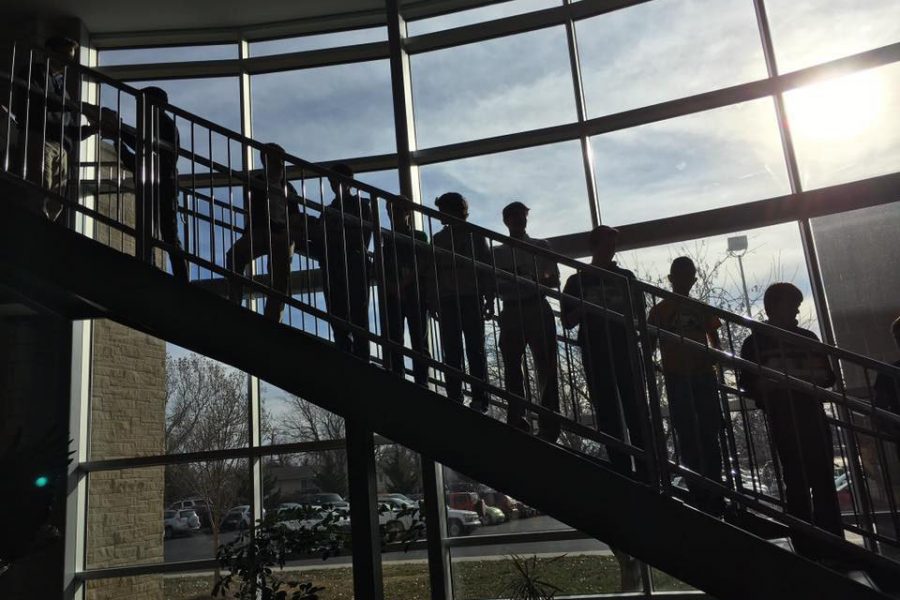 Students in an assembly line moved cans to The Cave. 