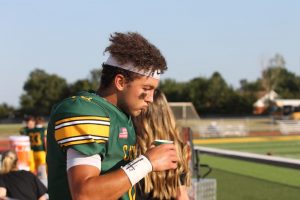 Golden Eagle starting Quarter Back, Aiden Niedens, taking a breather between an offensive series 